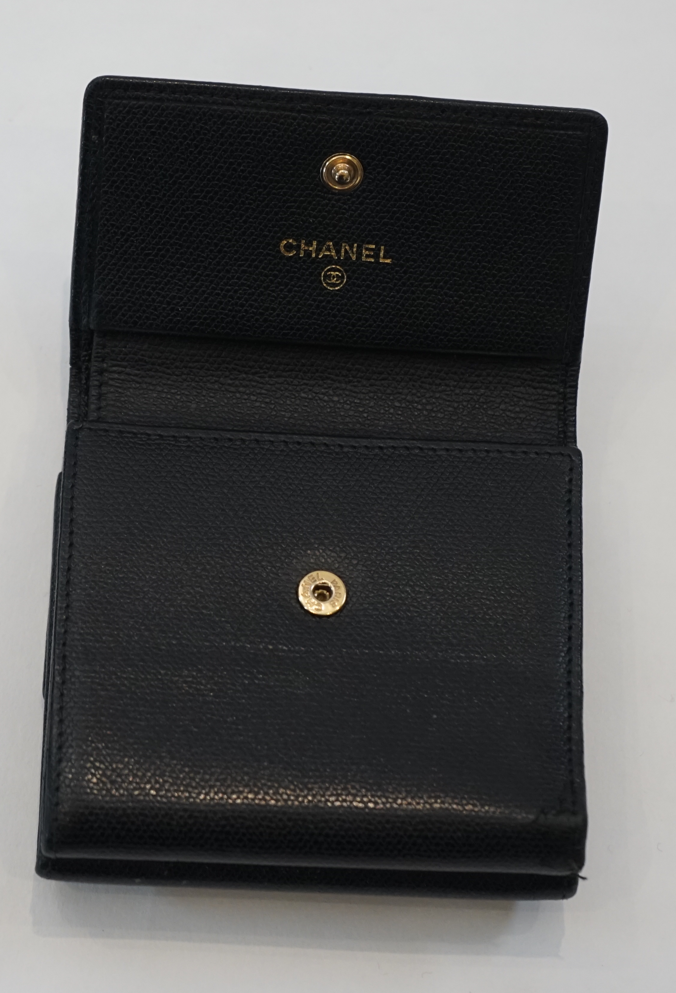 A Chanel black leather folded wallet width 10cm, depth 2cm, height 9.5cm